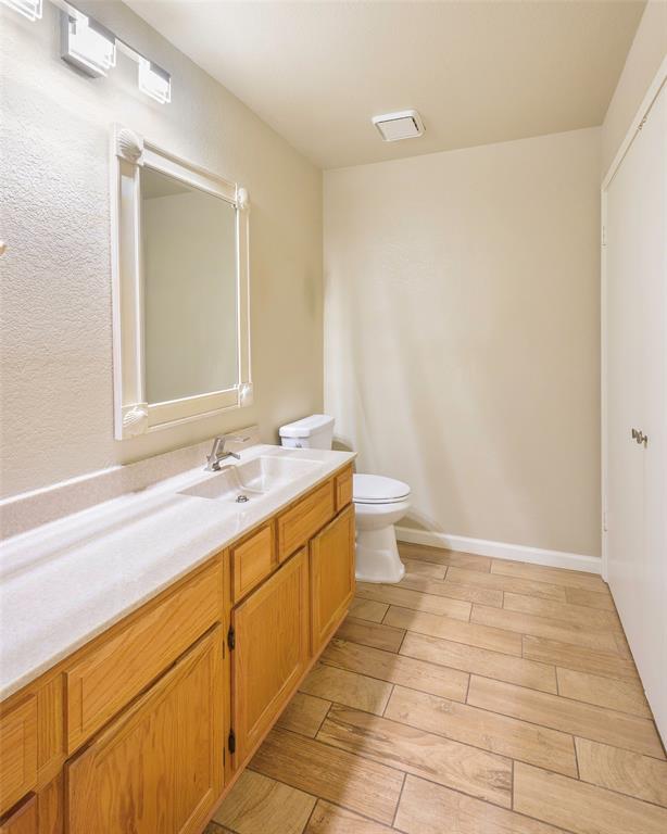 2903 Fort Point Lane Carrollton, TX 75007 - Photo 14 of 27 a bathroom with a sink a toilet and a mirror