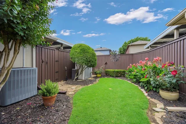 a front view of small house with yard and outdoor seating