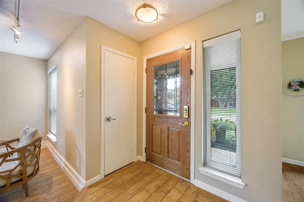 2903 Fort Point Lane Carrollton, TX 75007 - Photo 3 of 27 a view of a hallway with wooden floor and cabinet