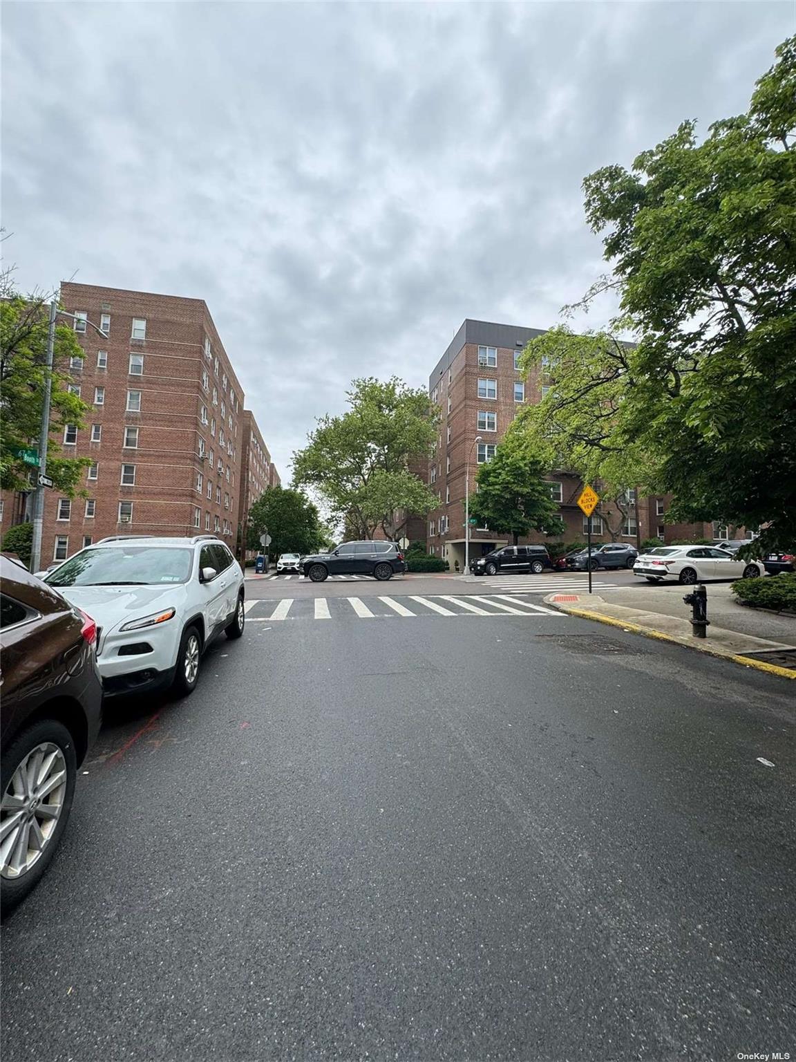 67-76 Booth Street, Unit 1G Queens, NY 11375 - Photo 13 of 15 a view of street with parked cars