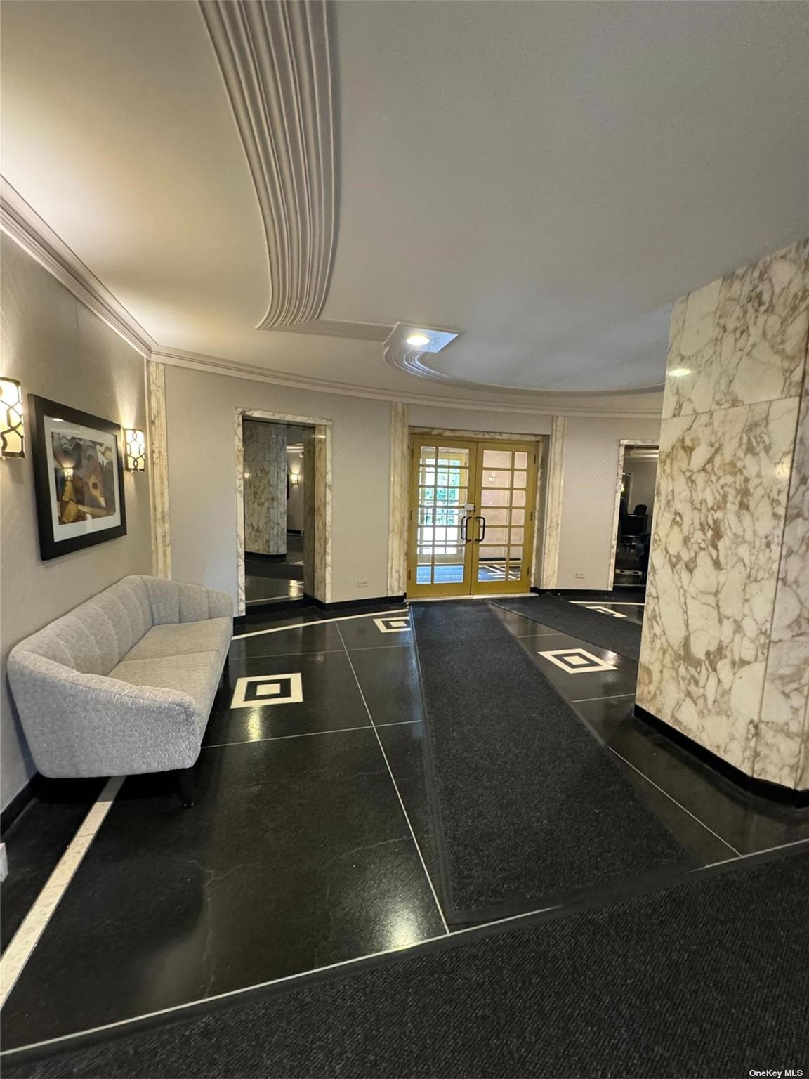 67-76 Booth Street, Unit 1G Queens, NY 11375 - Photo 4 of 15 a living room with furniture and a flat screen tv