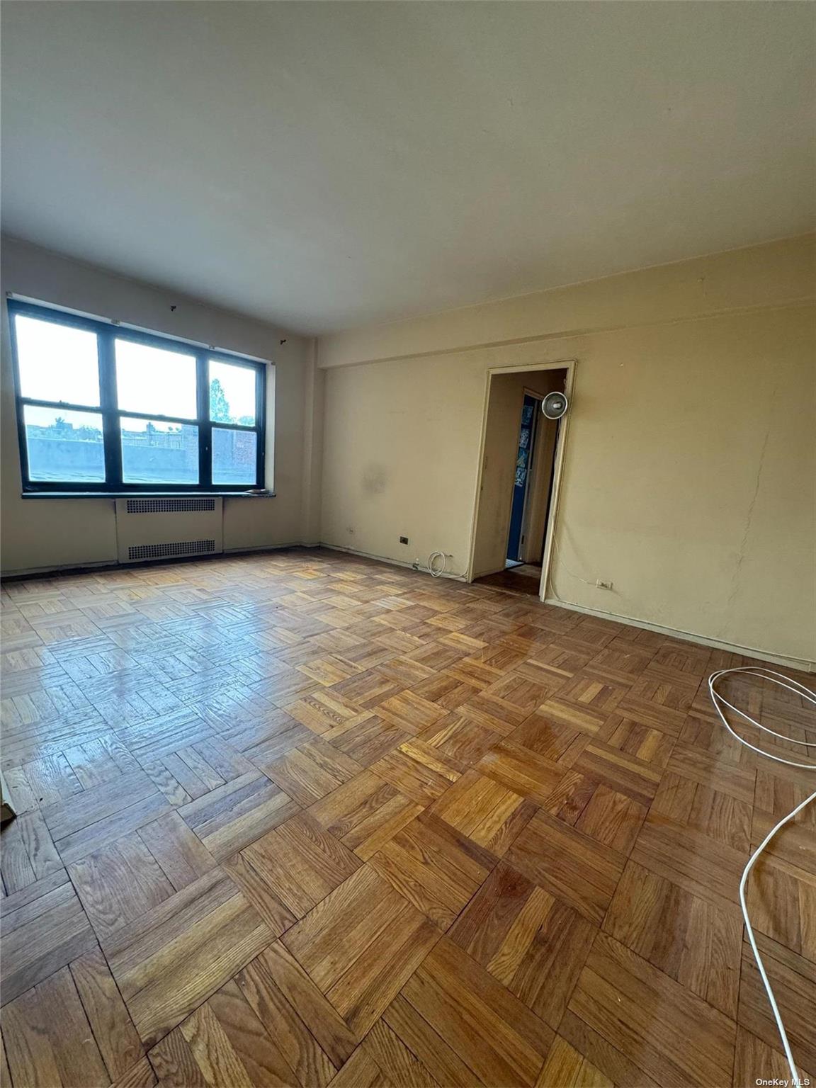 67-76 Booth Street, Unit 1G Queens, NY 11375 - Photo 7 of 15 an empty room with a fireplace
