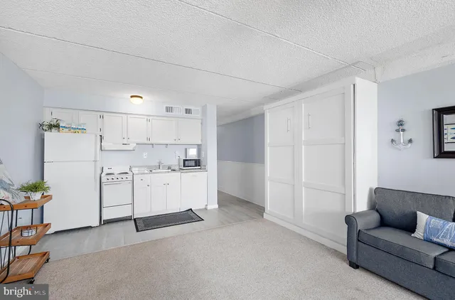 a spacious bedroom with a bed couch and a window