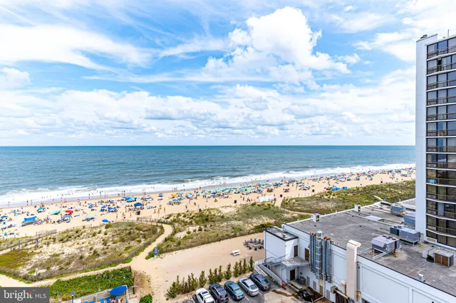 a view of a hallway to a livingroom with furniture