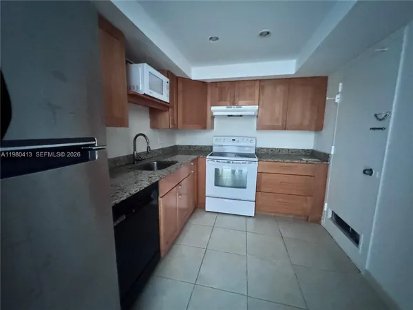 a kitchen with a cabinets and steel stainless steel appliances
