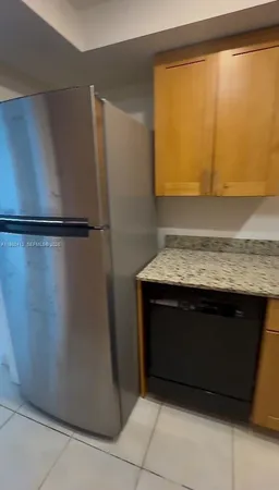 a kitchen with a refrigerator and a sink