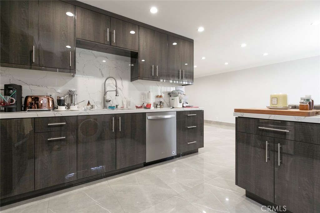 7901 Vía Stefano Burbank, CA 91504 - Photo 14 of 58 a kitchen with stainless steel appliances a sink stove and cabinets
