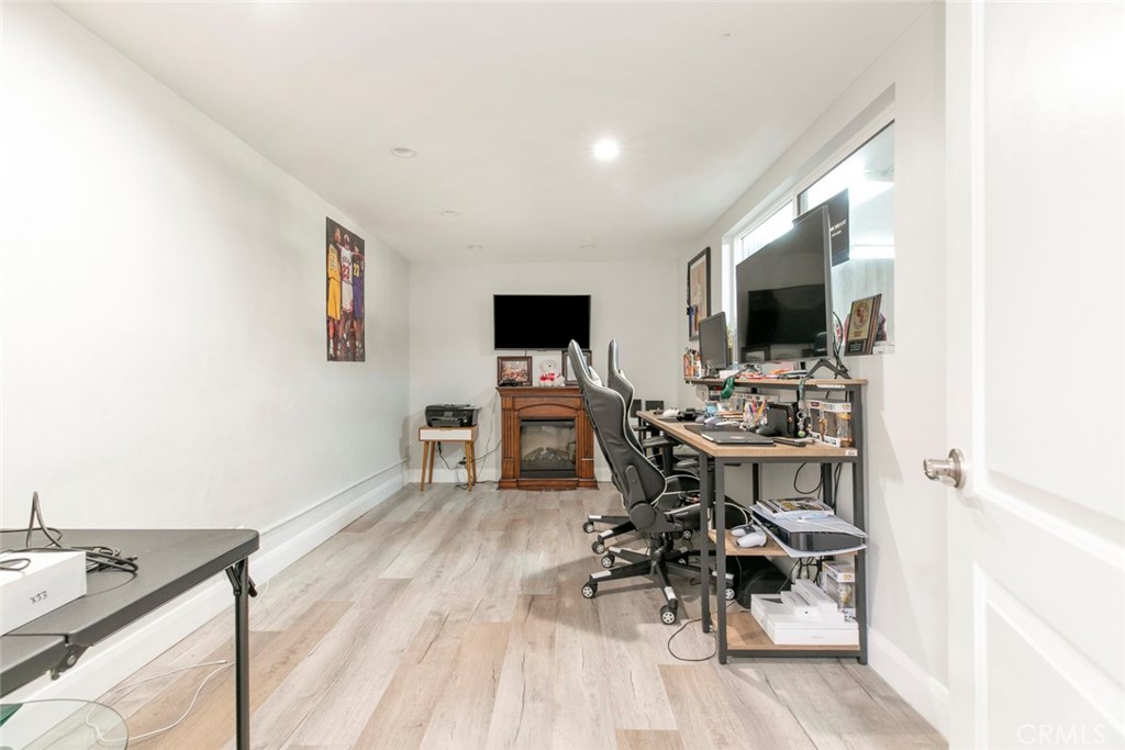 7901 Vía Stefano Burbank, CA 91504 - Photo 19 of 58 a view of a workspace with furniture and a flat screen tv