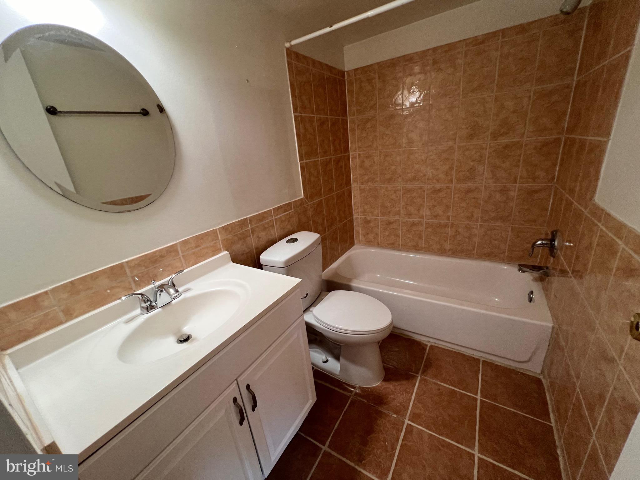 3964 Bel Pre Road, Unit 8 Silver Spring, MD 20906 - Photo 11 of 16 a bathroom with a sink a toilet and a mirror