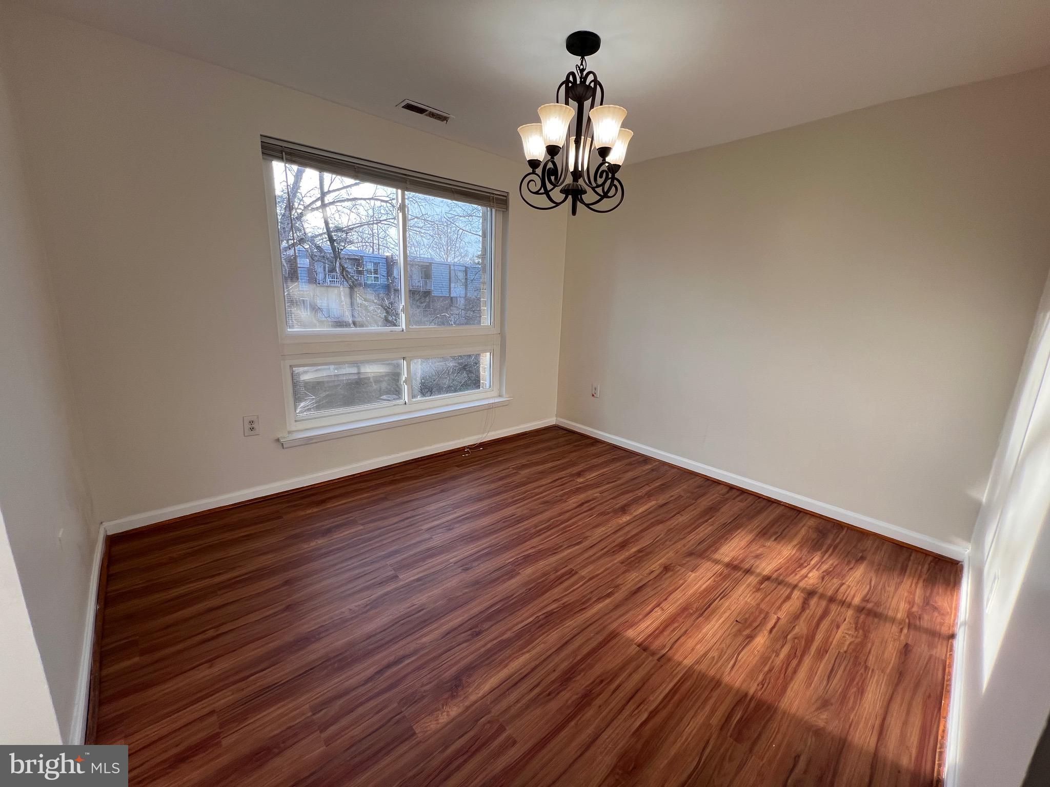 3964 Bel Pre Road, Unit 8 Silver Spring, MD 20906 - Photo 16 of 24 wooden floor in an empty room with a window