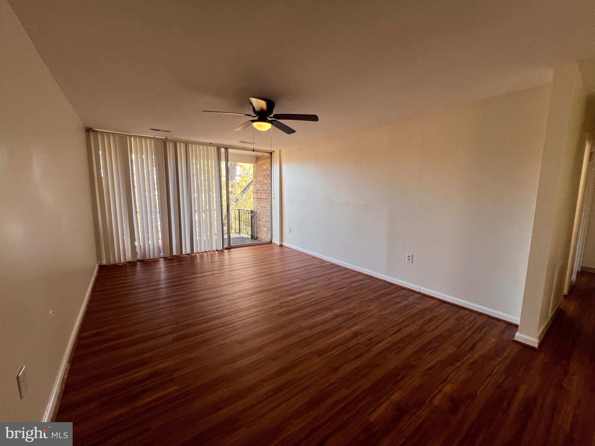 3964 Bel Pre Road, Unit 8 Silver Spring, MD 20906 - Photo 2 of 16 wooden floor in an empty room with a window