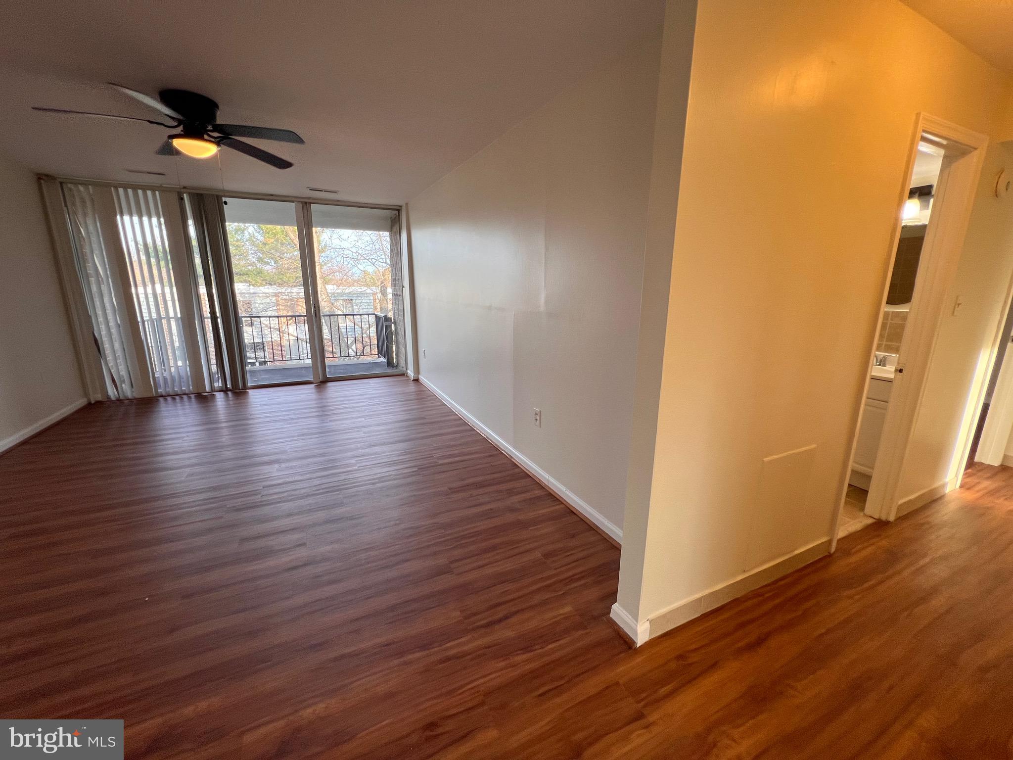 3964 Bel Pre Road, Unit 8 Silver Spring, MD 20906 - Photo 21 of 24 a view of an empty room with wooden floor and a window