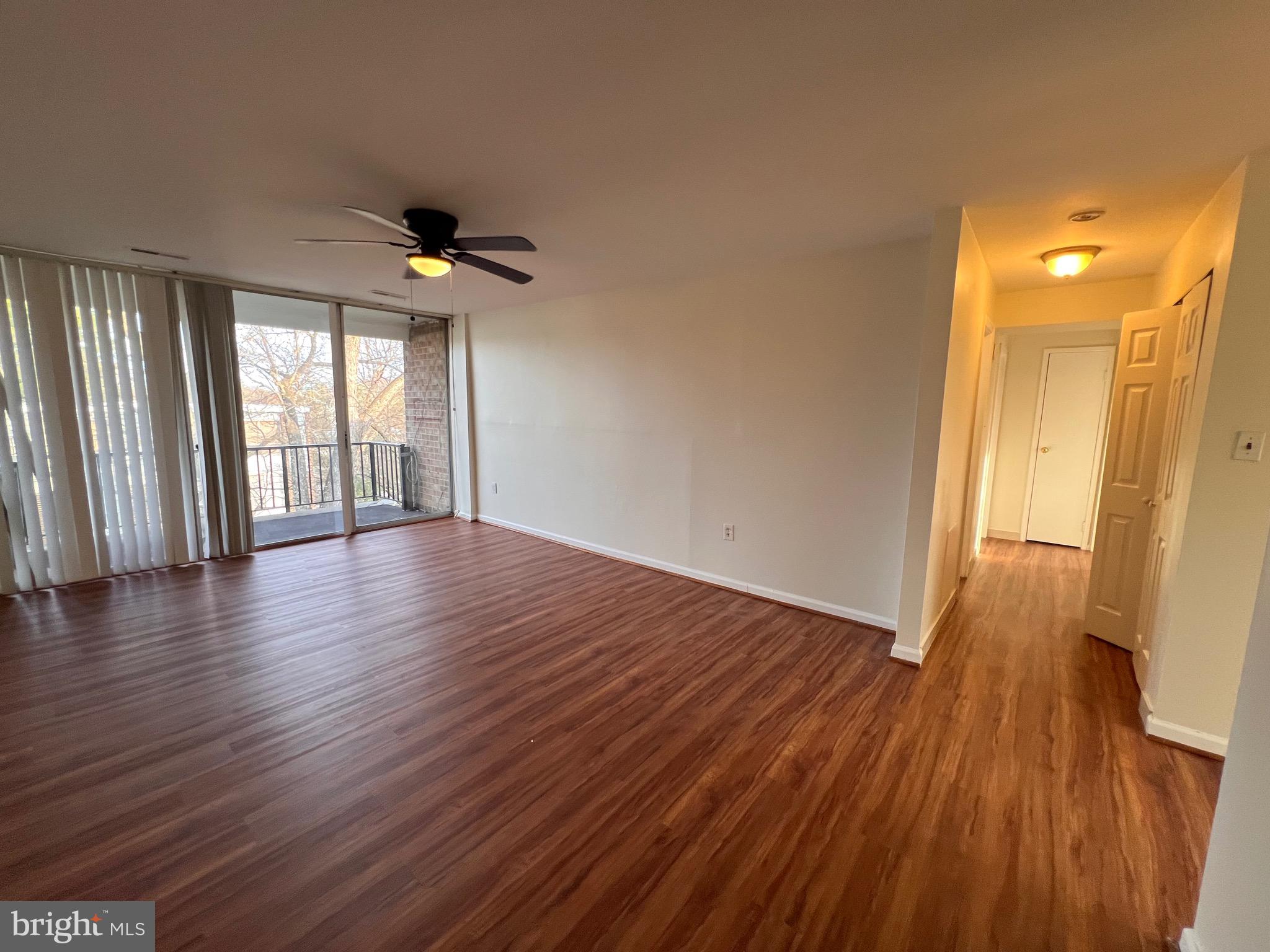 3964 Bel Pre Road, Unit 8 Silver Spring, MD 20906 - Photo 22 of 24 an empty room with wooden floor and windows
