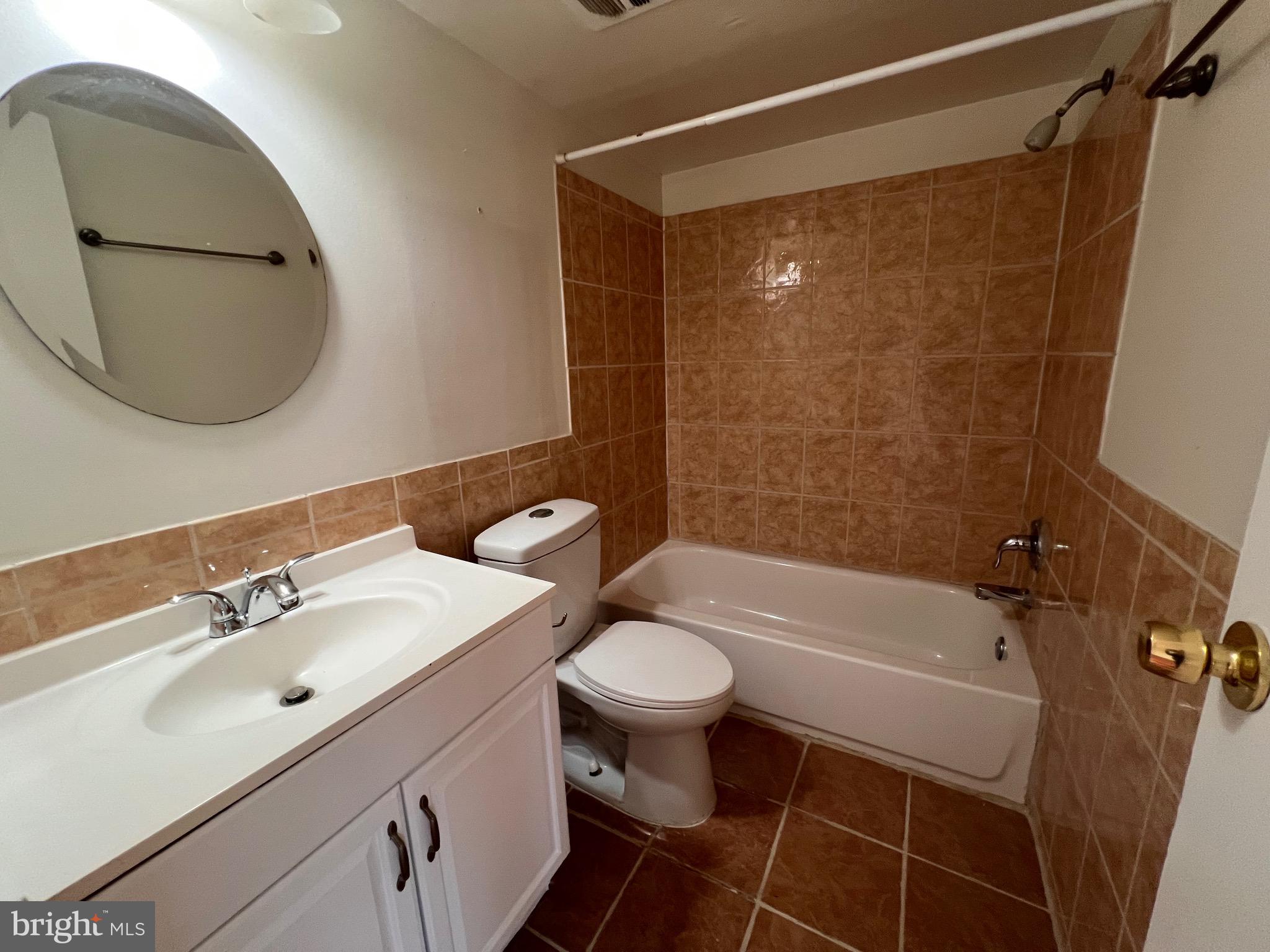 3964 Bel Pre Road, Unit 8 Silver Spring, MD 20906 - Photo 23 of 24 a bathroom with a sink toilet and shower