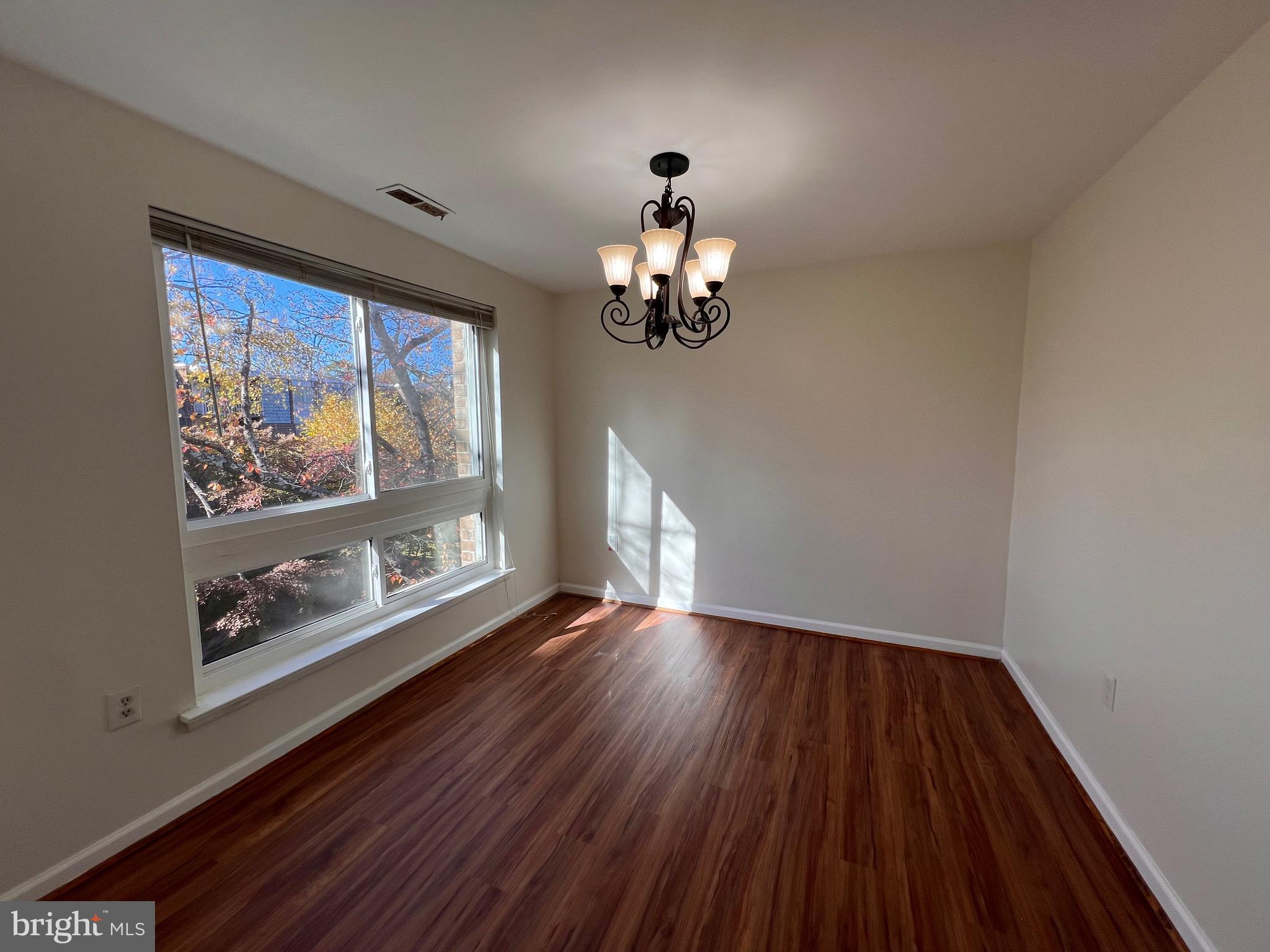 3964 Bel Pre Road, Unit 8 Silver Spring, MD 20906 - Photo 3 of 16 a view of wooden floor chandelier and window in a room