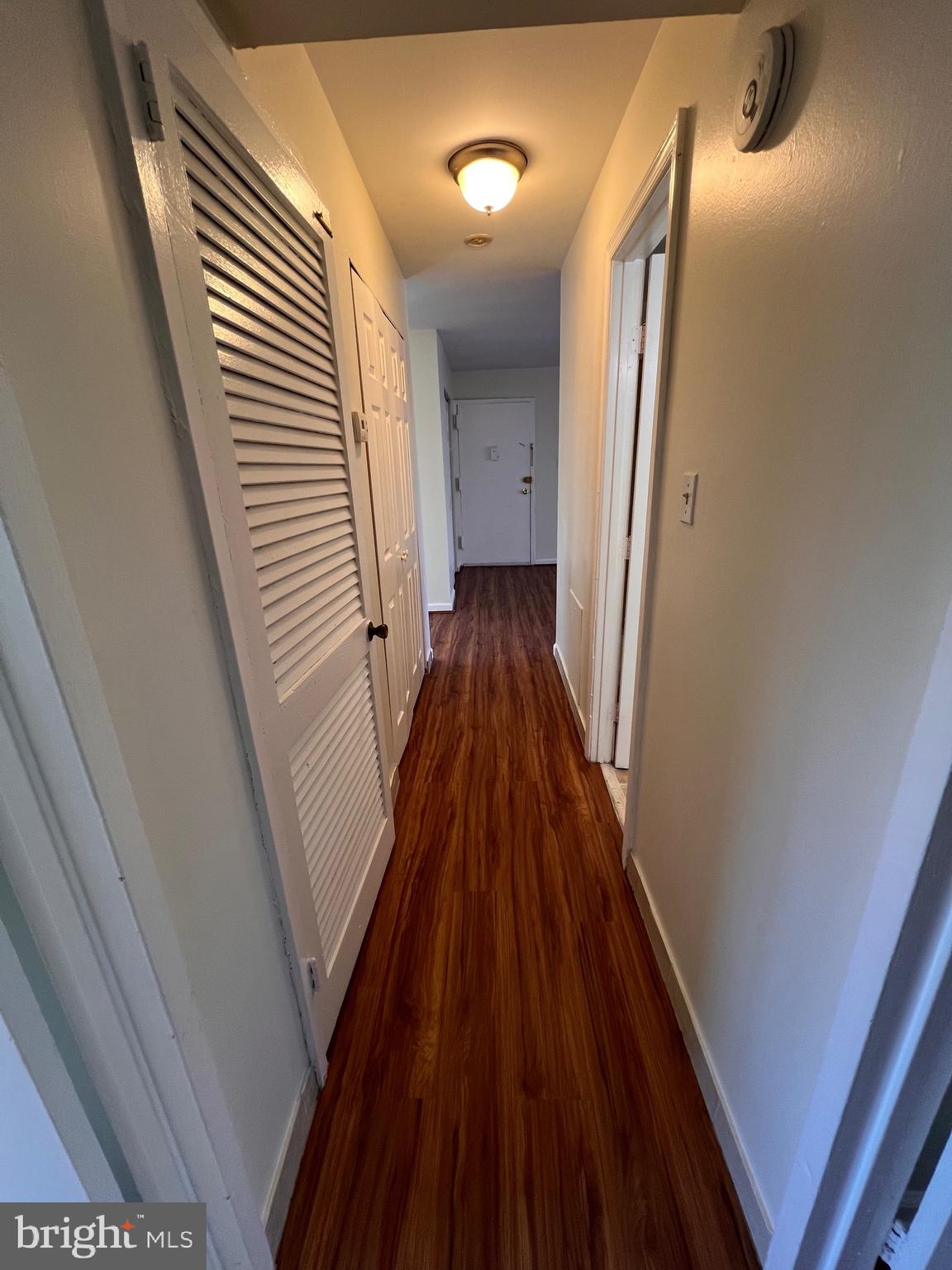3964 Bel Pre Road, Unit 8 Silver Spring, MD 20906 - Photo 7 of 16 a view of a hallway with wooden floor