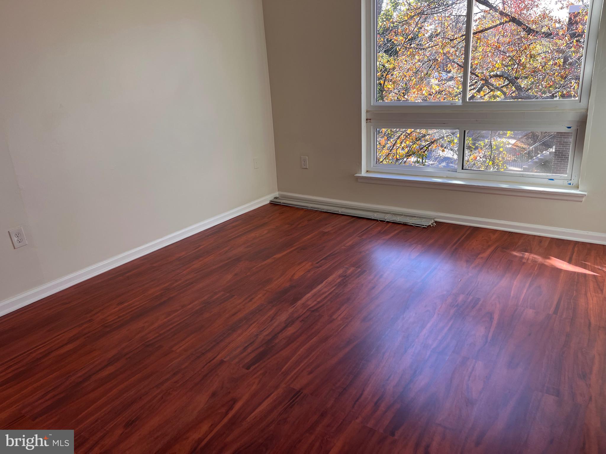 3964 Bel Pre Road, Unit 8 Silver Spring, MD 20906 - Photo 8 of 16 a view of a room with wooden floor and a window