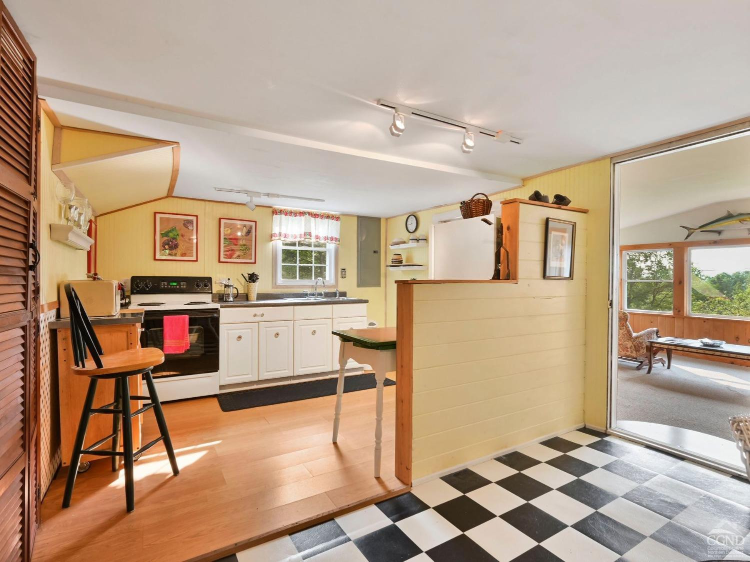 157 Horseshoe Road Conesville, NY 12076 - Photo 11 of 48 a living room with stainless steel appliances kitchen island granite countertop furniture and a rug