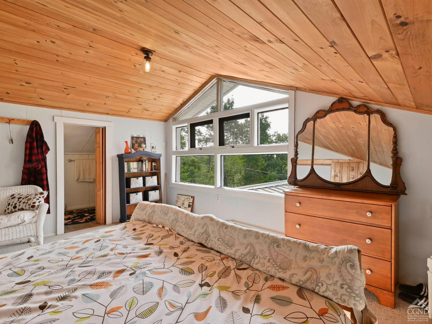 157 Horseshoe Road Conesville, NY 12076 - Photo 18 of 48 a bed sitting in a bedroom next to a window