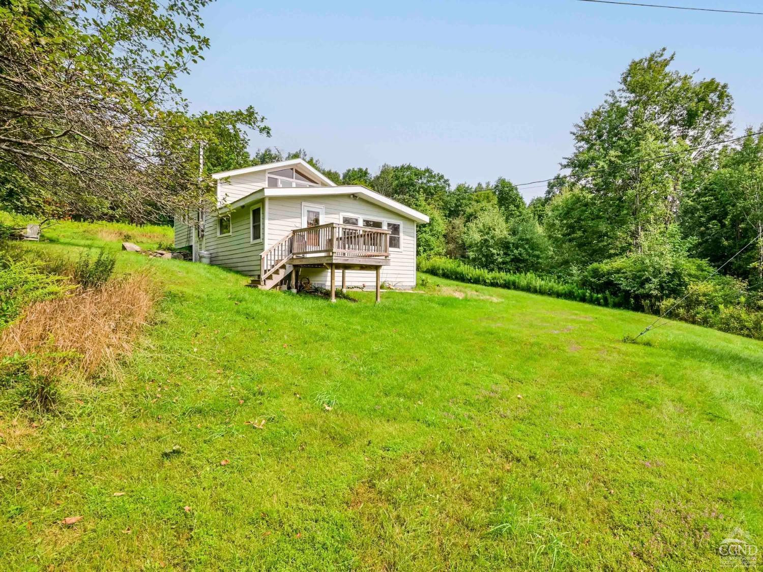 157 Horseshoe Road Conesville, NY 12076 - Photo 36 of 48 a house with a big yard with large trees