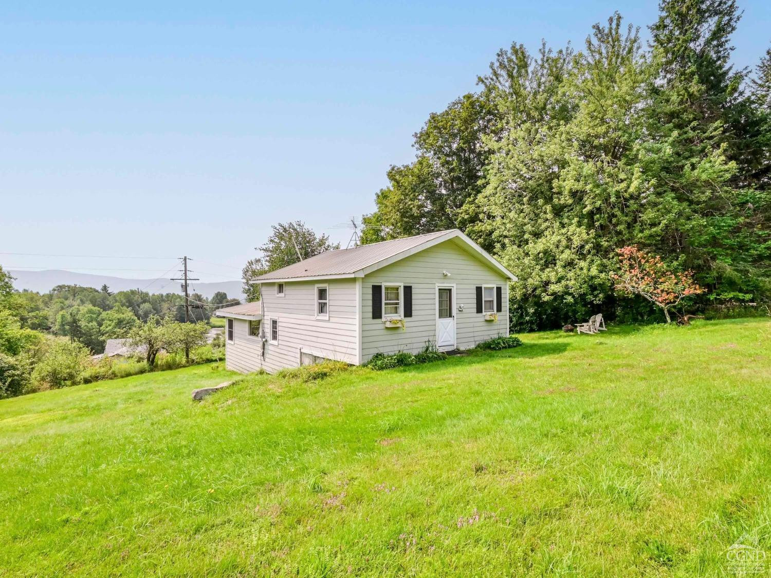 157 Horseshoe Road Conesville, NY 12076 - Photo 4 of 48 a view of a house in front of a big yard with large trees