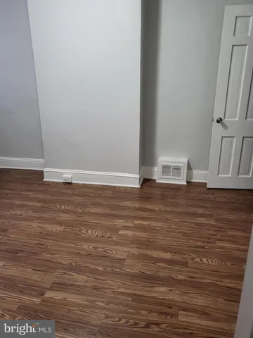 a view of room with wooden floor