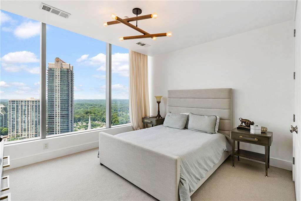 3630 Peachtree Road Northeast, Unit 2005 Atlanta, GA 30326 - Photo 14 of 32 a bedroom with a large bed and a large window