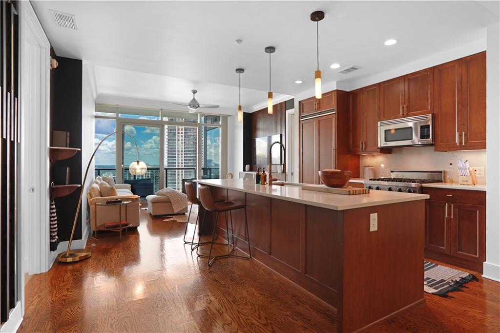 3630 Peachtree Road Northeast, Unit 2005 Atlanta, GA 30326 - Photo 2 of 32 a large kitchen with kitchen island a large island in it