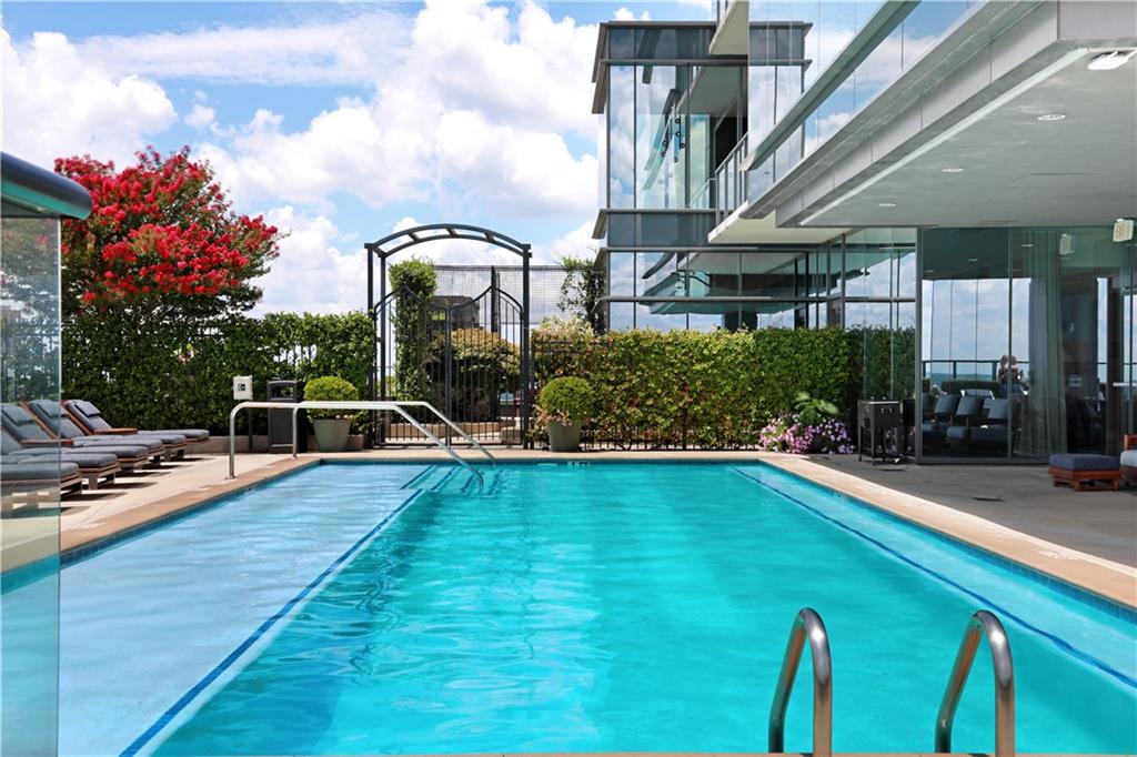 3630 Peachtree Road Northeast, Unit 2005 Atlanta, GA 30326 - Photo 24 of 32 a swimming pool with outdoor seating and yard