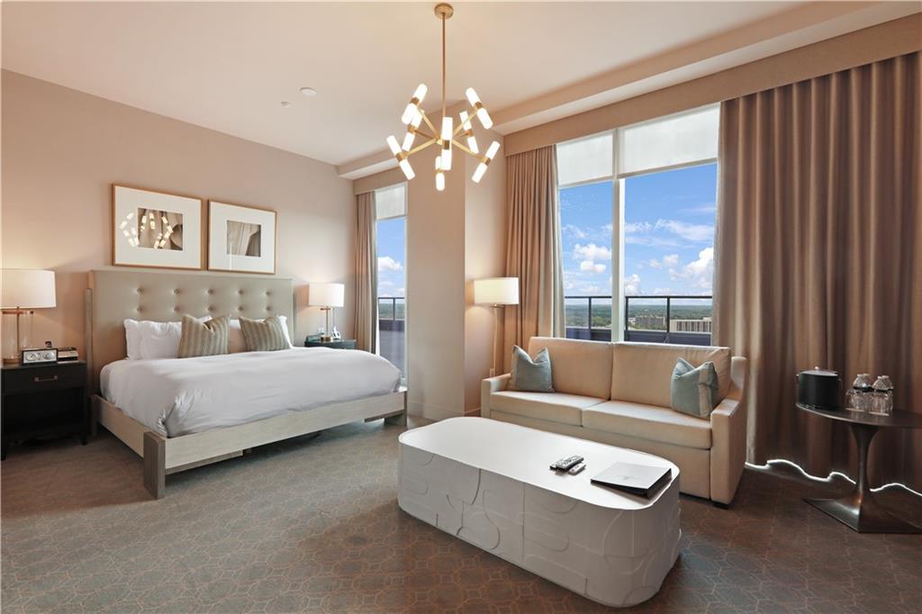 3630 Peachtree Road Northeast, Unit 2005 Atlanta, GA 30326 - Photo 29 of 32 a spacious bedroom with a bed and a chandelier