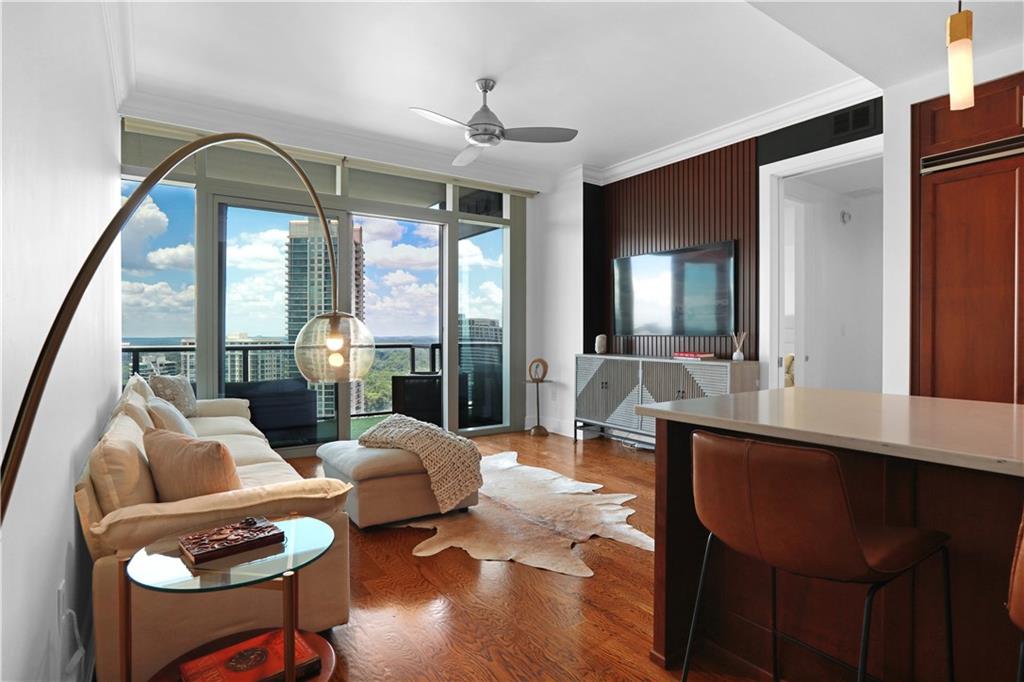 3630 Peachtree Road Northeast, Unit 2005 Atlanta, GA 30326 - Photo 3 of 32 a living room with furniture and wooden floor