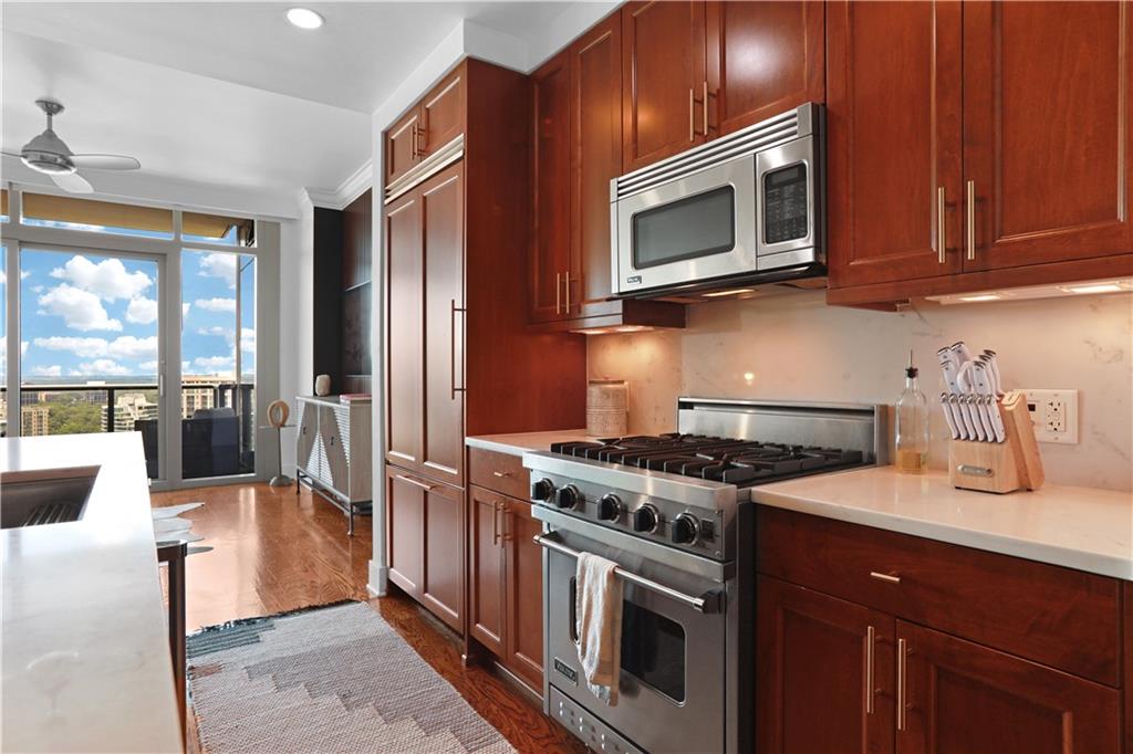 3630 Peachtree Road Northeast, Unit 2005 Atlanta, GA 30326 - Photo 8 of 32 a kitchen with stainless steel appliances granite countertop a stove microwave and refrigerator