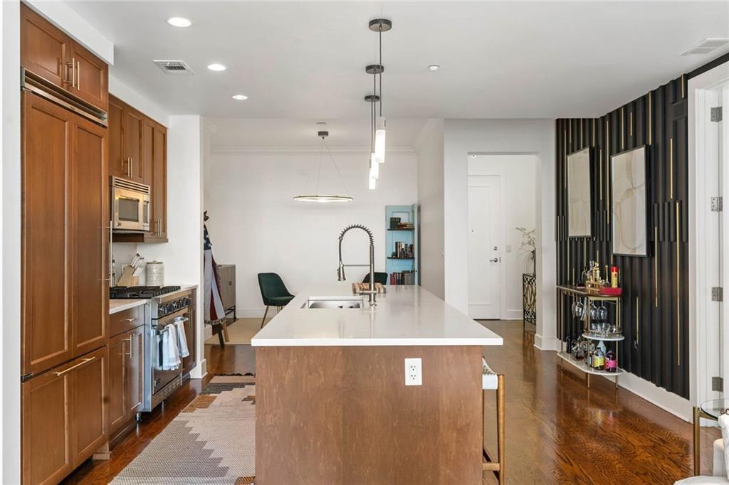 3630 Peachtree Road Northeast, Unit 2005 Atlanta, GA 30326 - Photo 9 of 32 a kitchen with kitchen island granite countertop a sink stove and refrigerator