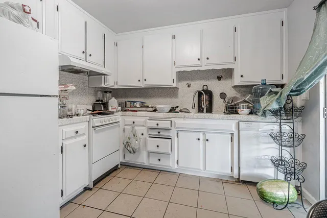 a kitchen with cabinets appliances and a sink