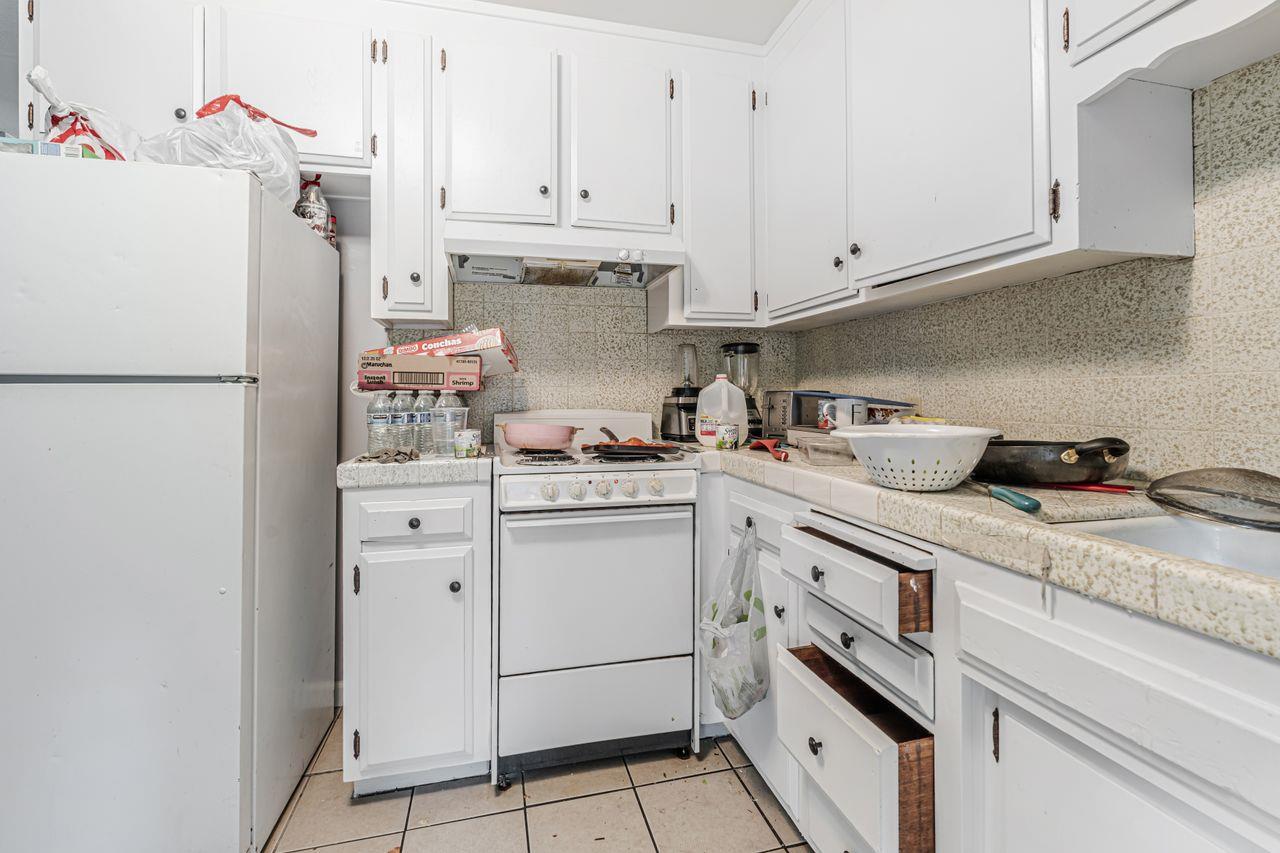 2210 San Blas Court Modesto, CA 95355 - Photo 14 of 28 a kitchen with cabinets appliances and a refrigerator