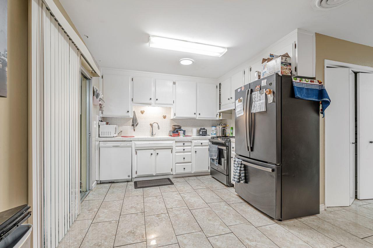 2210 San Blas Court Modesto, CA 95355 - Photo 15 of 28 a kitchen with a refrigerator sink and cabinets