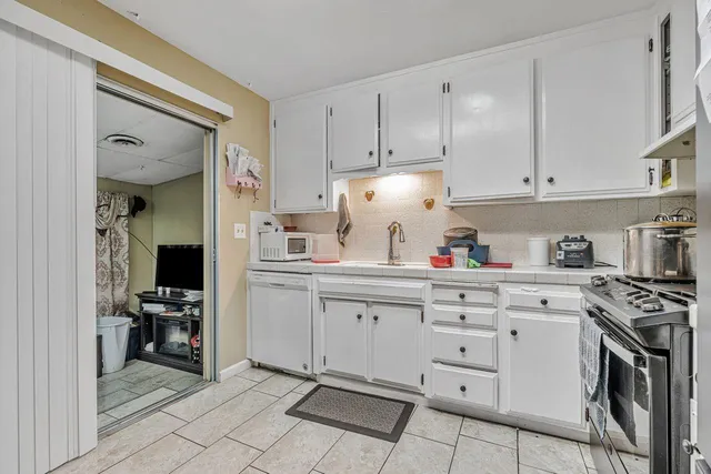 a view of a livingroom with furniture and a flat screen tv