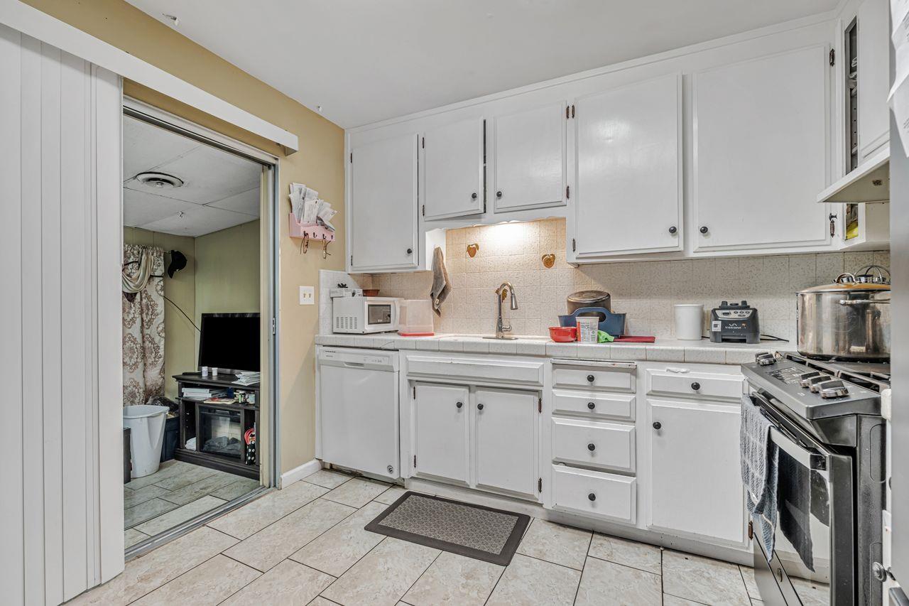 2210 San Blas Court Modesto, CA 95355 - Photo 16 of 28 a kitchen with white cabinets and appliances