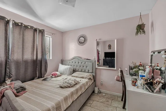 a bedroom with a bed and a flat tv screen