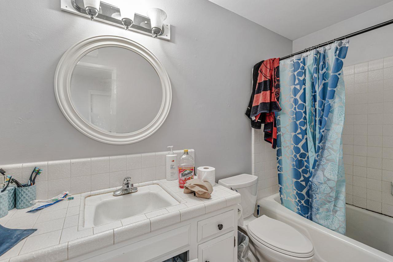 2210 San Blas Court Modesto, CA 95355 - Photo 25 of 28 a bathroom with a sink a toilet and a mirror