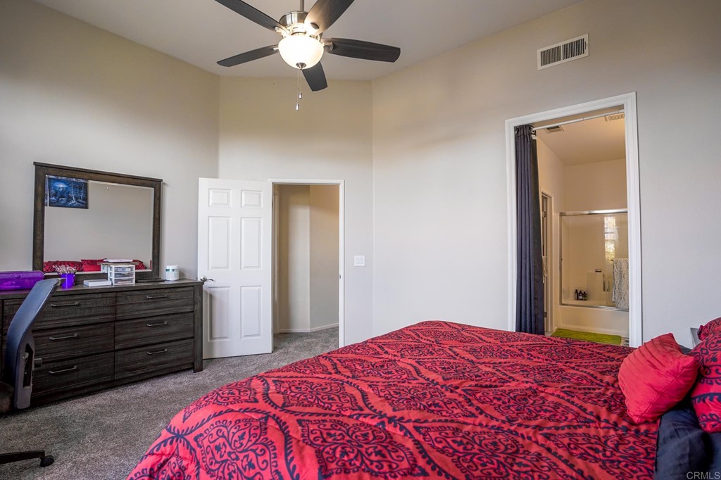 629 Sumner Way, Unit 2 Oceanside, CA 92058 - Photo 11 of 21 a bedroom with a bed and a chandelier