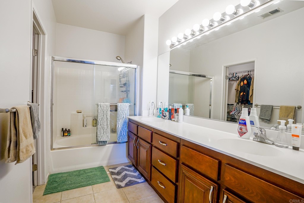 629 Sumner Way, Unit 2 Oceanside, CA 92058 - Photo 13 of 21 a spacious bathroom with a double vanity sink a large mirror a shower and bathtub