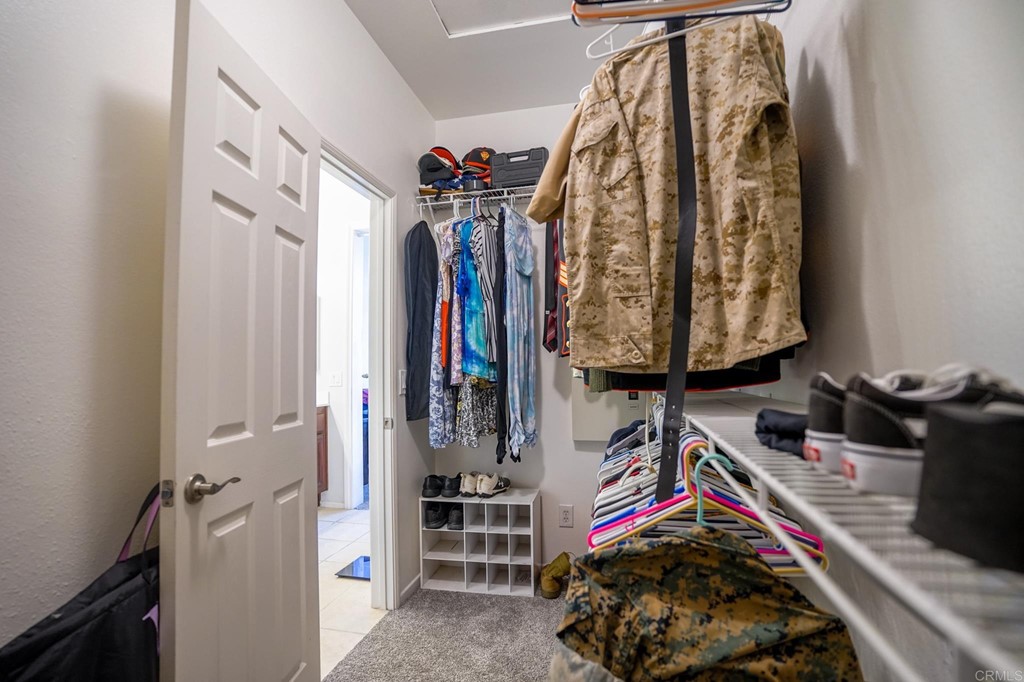 629 Sumner Way, Unit 2 Oceanside, CA 92058 - Photo 15 of 21 a view of walk in closet with clothes and shoes