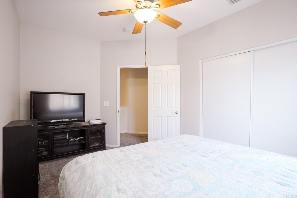 629 Sumner Way, Unit 2 Oceanside, CA 92058 - Photo 17 of 21 a bedroom with a bed and a flat screen tv