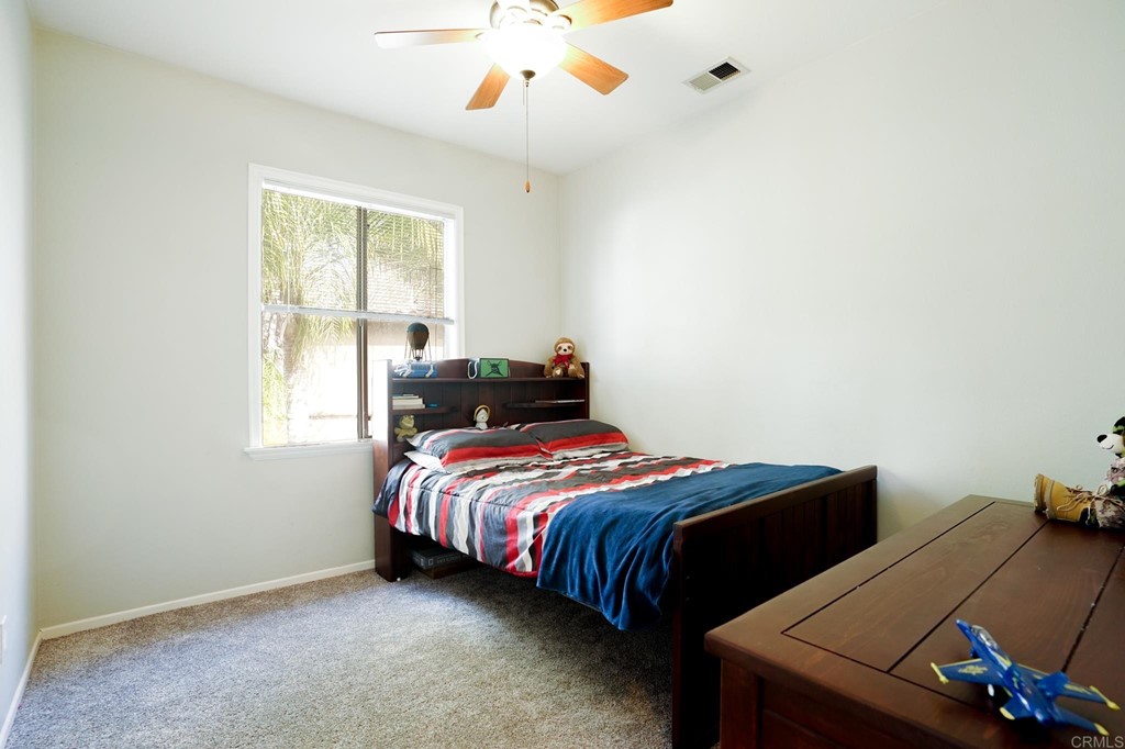 629 Sumner Way, Unit 2 Oceanside, CA 92058 - Photo 18 of 21 a bedroom with a bed and a window