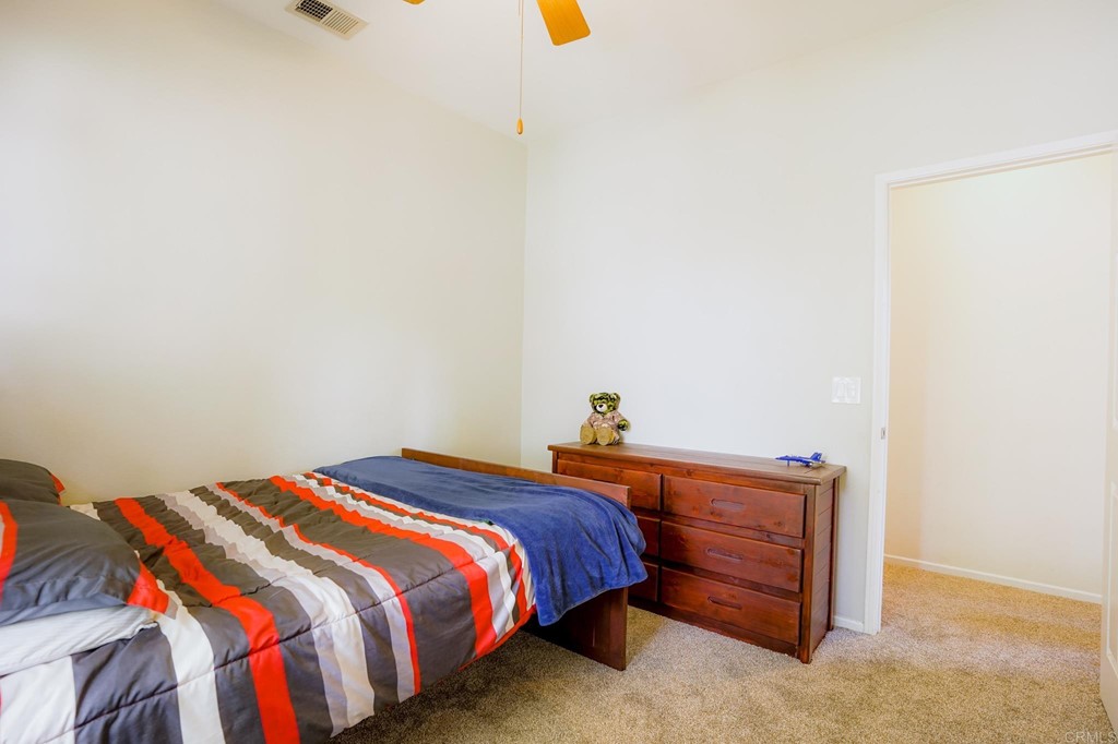 629 Sumner Way, Unit 2 Oceanside, CA 92058 - Photo 19 of 21 a bedroom with a bed and cabinets