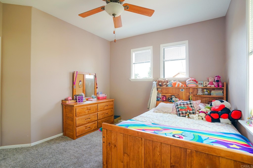 629 Sumner Way, Unit 2 Oceanside, CA 92058 - Photo 20 of 21 a bedroom with a bed and a dresser