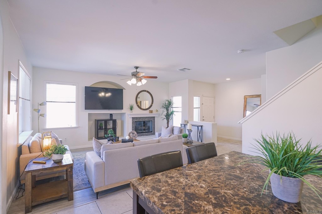 629 Sumner Way, Unit 2 Oceanside, CA 92058 - Photo 5 of 21 a living room with furniture a window and a clock