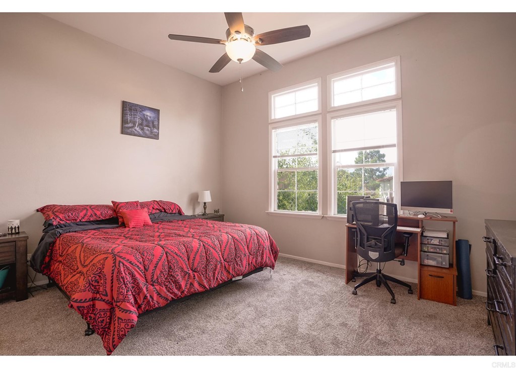 629 Sumner Way, Unit 2 Oceanside, CA 92058 - Photo 9 of 21 a bedroom with a bed and a desk