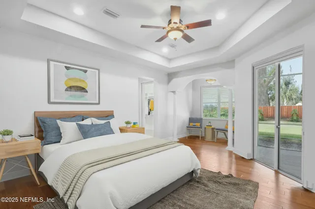 a bedroom with a large bed and a chandelier